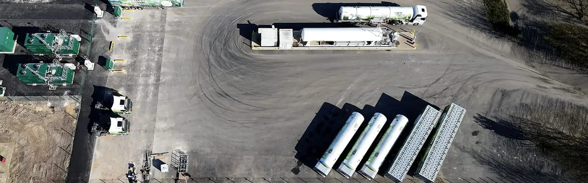 Aerial view of Bio-LNG refuelling station with gas trucks and storage tanks, emphasizing renewable gas solutions for UK HGV fleets.