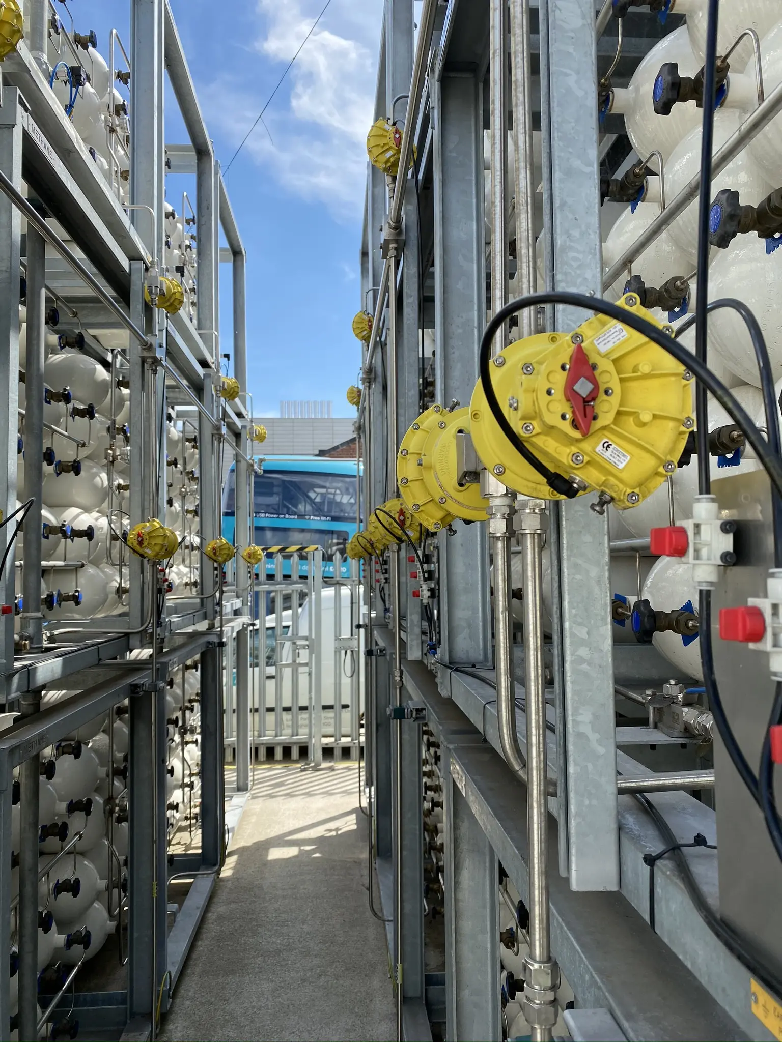 A view of renewable gas refuelling infrastructure with pipes and valves, essential for low-carbon transport solutions for UK HGV fleets.