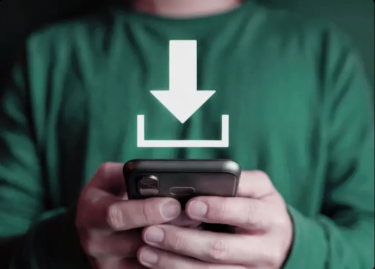 Person holding a smartphone with a download icon, representing mobile app usage for fleet management