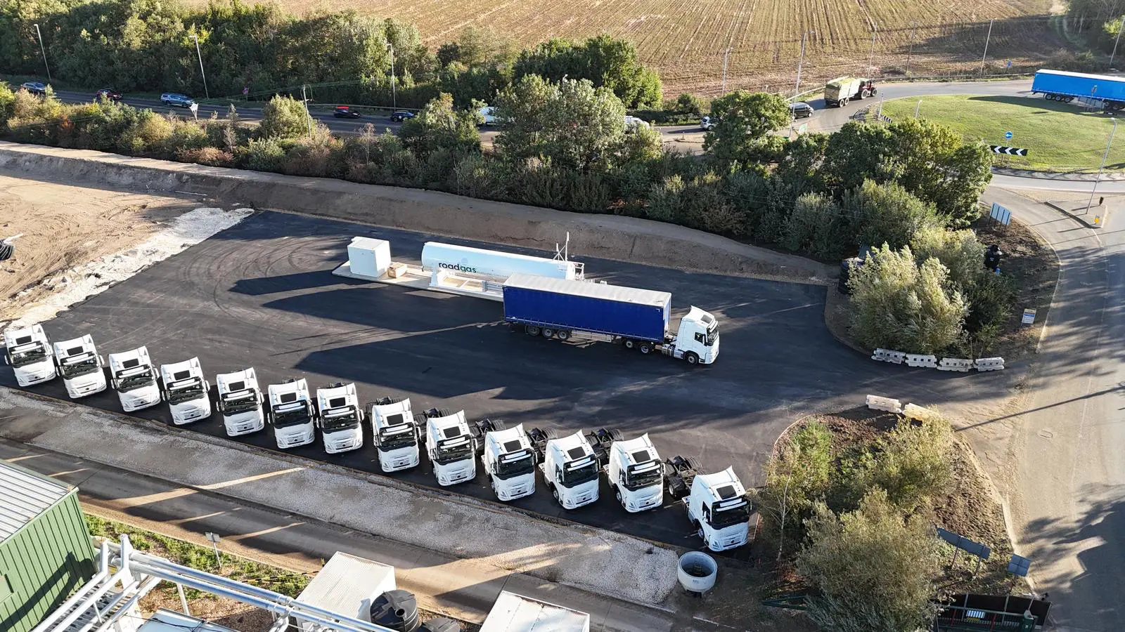 Aerial view of a Roadgas refuelling station featuring multiple gas trucks and a Bio-LNG supply unit, showcasing renewable gas infrastructure for UK HGV fleets.