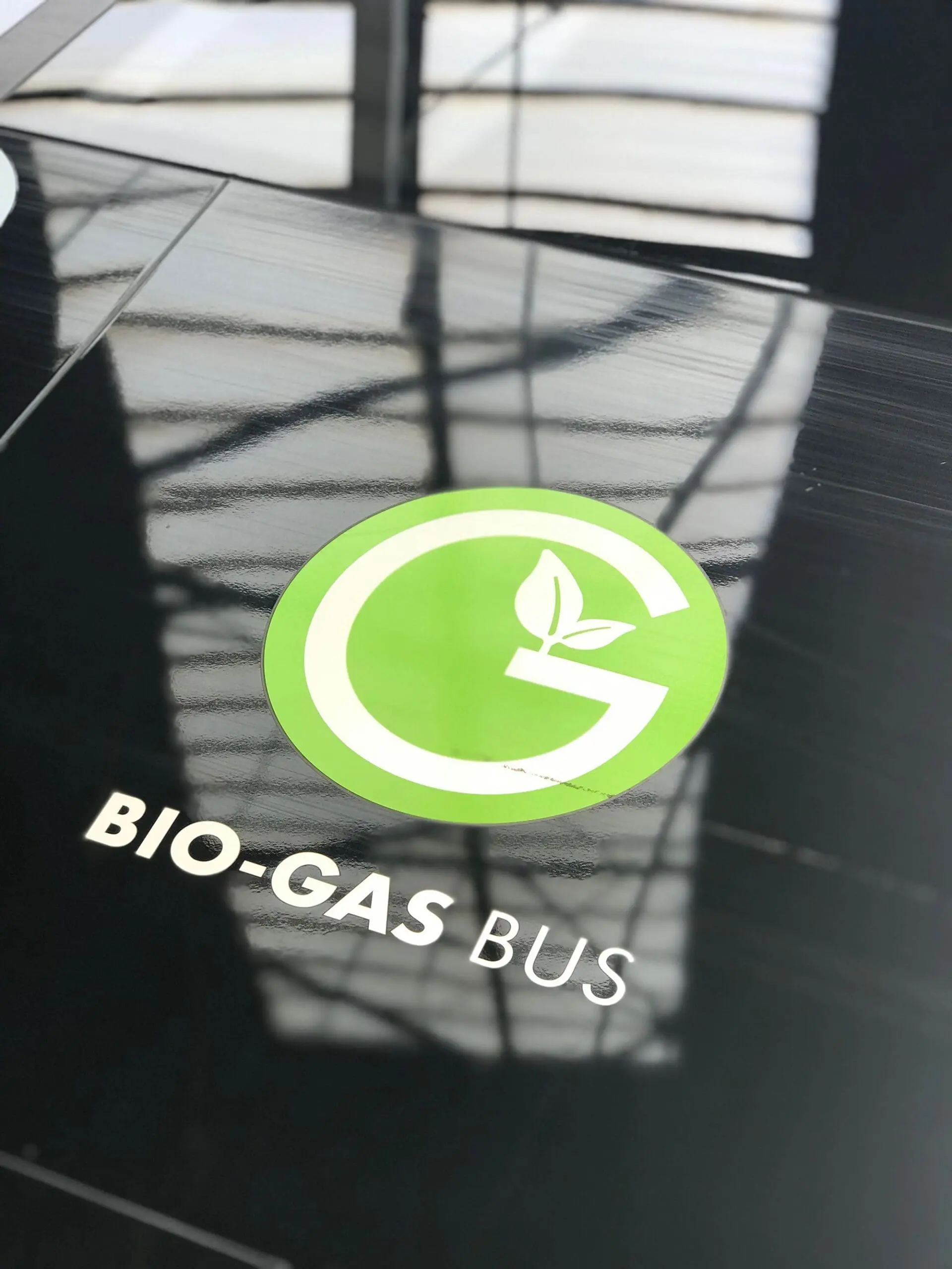 Close-up of a Bio-Gas Bus logo highlighting the use of renewable gas in transportation