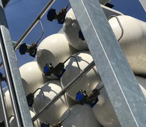 Close-up of renewable gas storage tanks showing valves and piping, essential for Bio-LNG and Bio-CNG refuelling infrastructure.