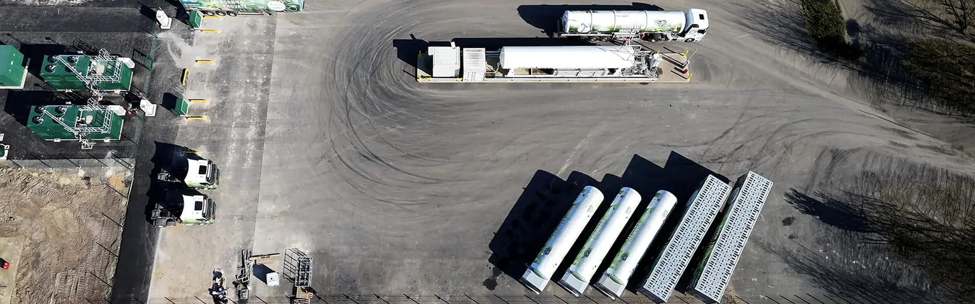 Aerial view of Bio-LNG refuelling station with gas trucks and storage tanks, emphasizing renewable gas solutions for UK HGV fleets.