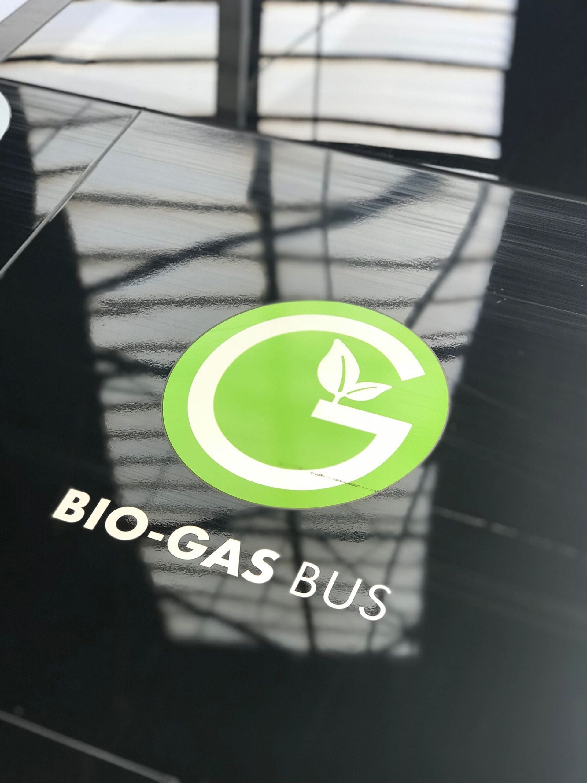 Close-up of a Bio-Gas Bus logo highlighting the use of renewable gas in transportation